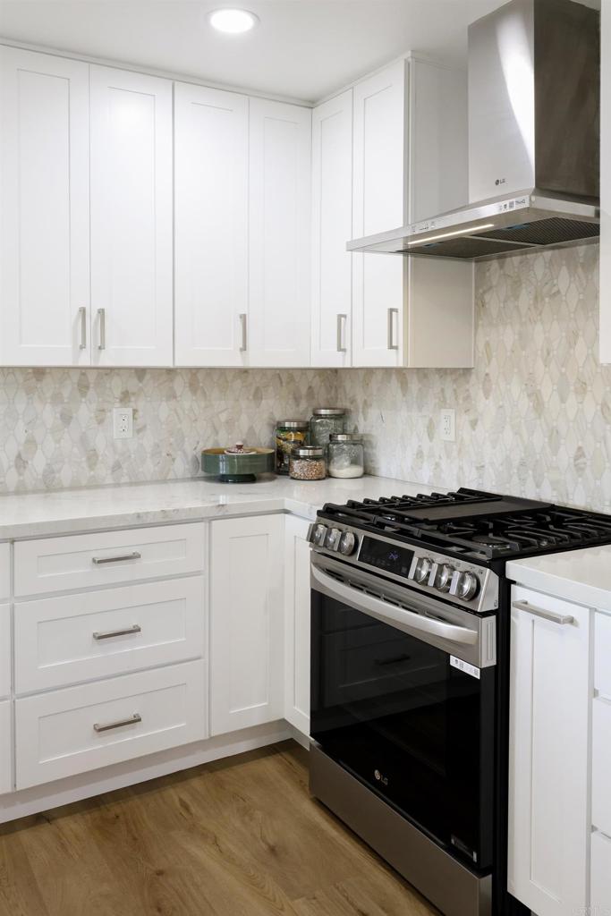 1024 Ransom Street San Diego, CA 92154 - Photo 3 of 41 a kitchen with granite countertop white cabinets and a stove
