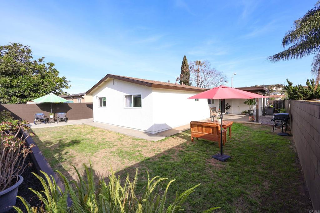 1024 Ransom Street San Diego, CA 92154 - Photo 38 of 41 a view of a backyard with table and chairs under an umbrella