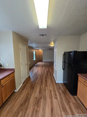 a view of hallway with wooden floor