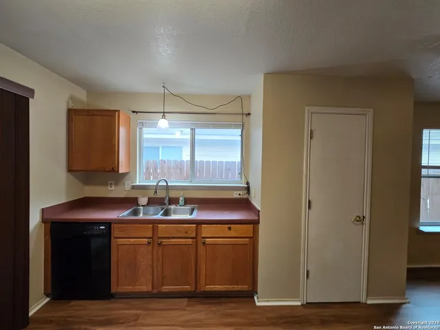 a kitchen with sink and window