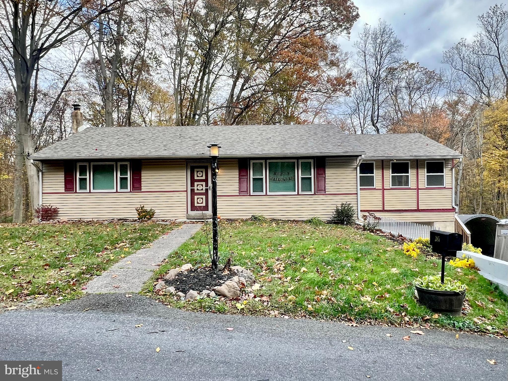 385 Sycamore Road Douglassville, PA 19518 - Photo 2 of 3 a front view of a house with garden