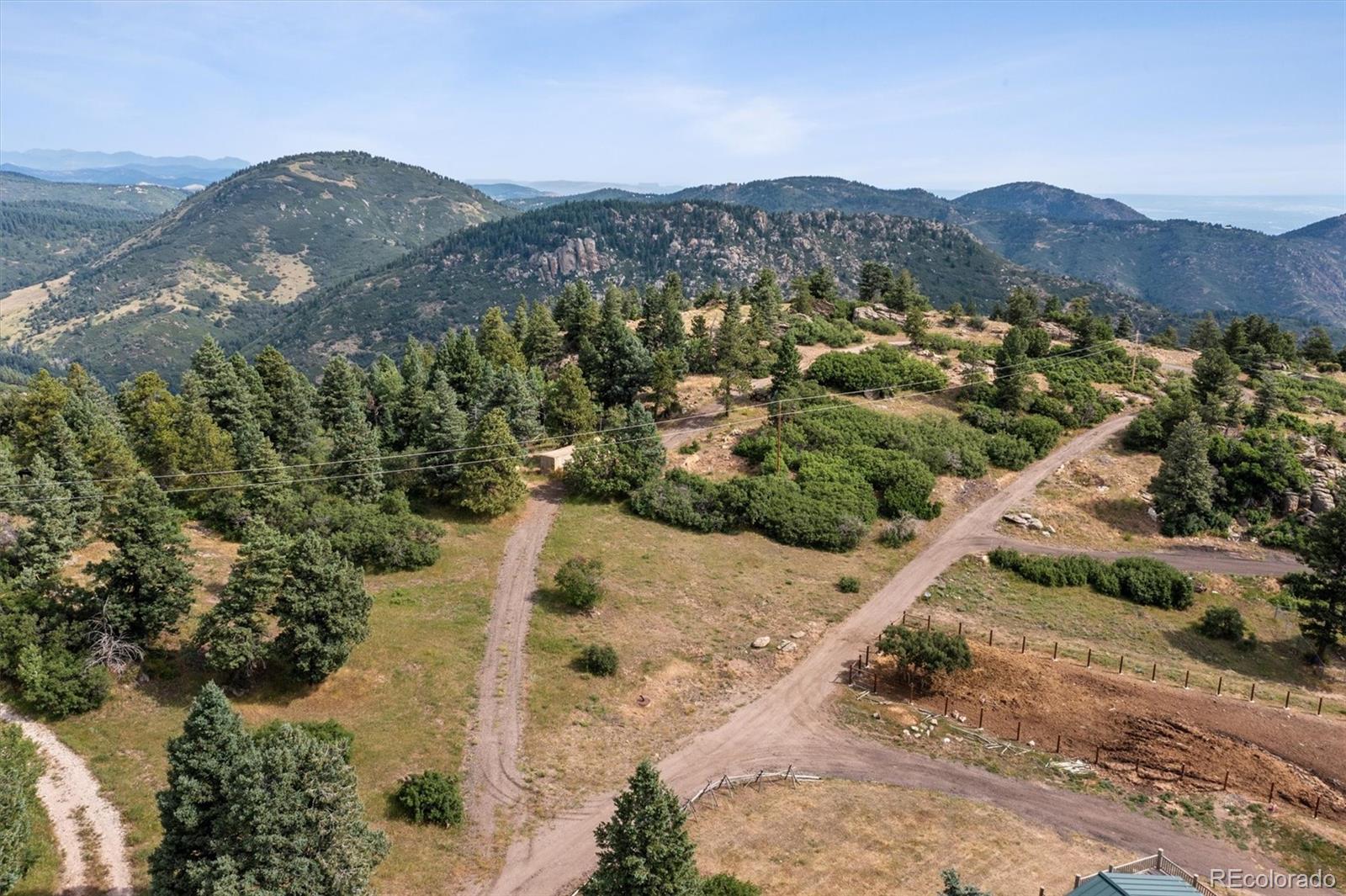 13854 North Trail Circle Littleton, CO 80127 - Photo 15 of 17 a view of a forest with mountains in the background