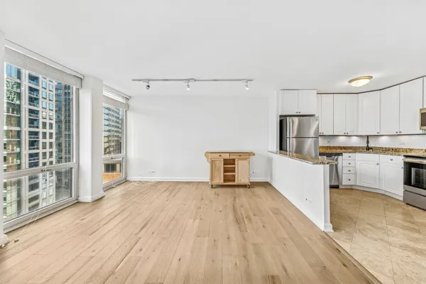a view of kitchen with stainless steel appliances refrigerator oven and cabinets
