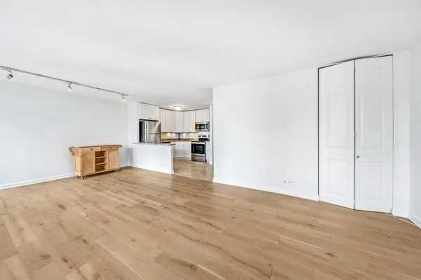 a view of a kitchen with a sink and a refrigerator