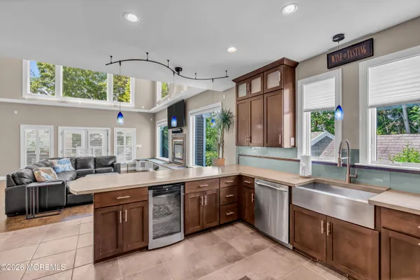 a bathroom with a tub a sink and a large window