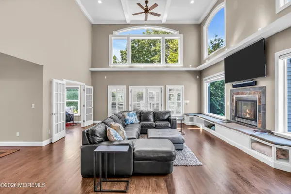 a view of a house with a large window and wooden fence