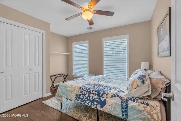 a view of a house with a big yard plants and large trees