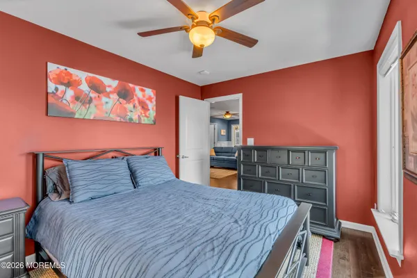 a living room with wooden floor and furniture