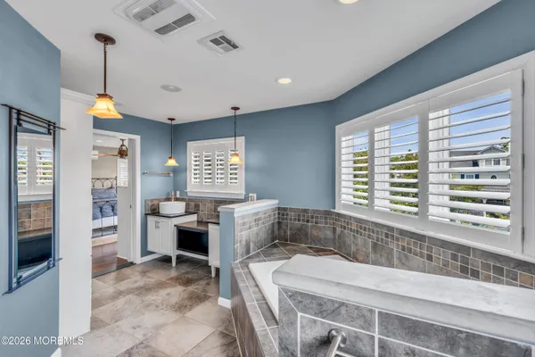a living room with fireplace furniture and a large window