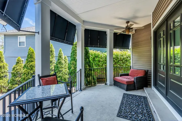 a dining room with furniture a large window and a chandelier