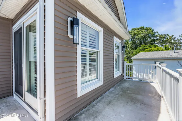 a living room with stainless steel appliances granite countertop furniture and a fireplace