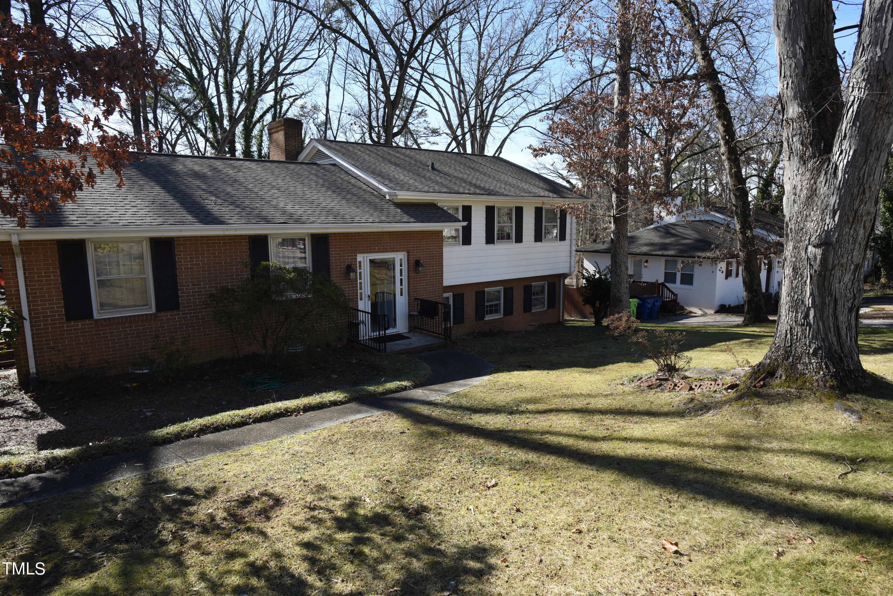 a view of a white house with a yard covered with snow