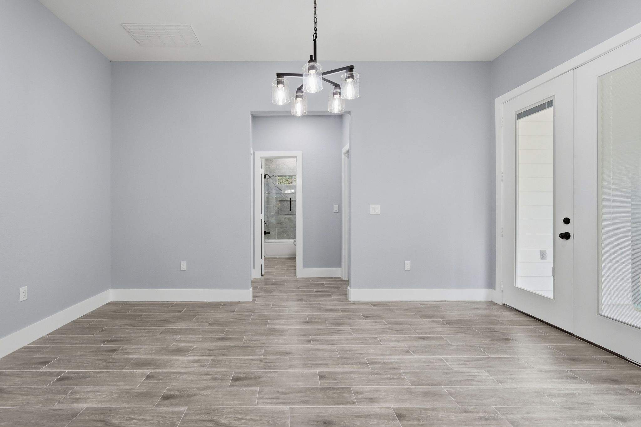 3575 Roy Bean Road Willis, TX 77378 - Photo 12 of 40 a view of a room with wooden floor and white walls