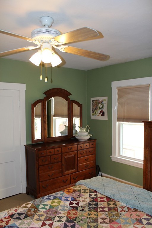 58 Larkspur Street Springfield, MA 01108 - Photo 20 of 29 a bedroom with a bed and a chandelier