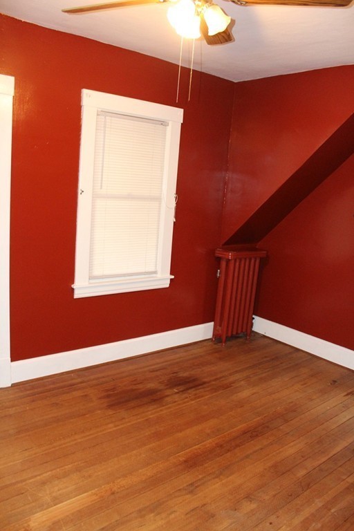 58 Larkspur Street Springfield, MA 01108 - Photo 21 of 29 an empty room with wooden floor and windows