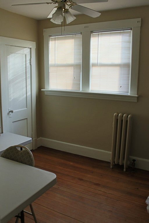 58 Larkspur Street Springfield, MA 01108 - Photo 25 of 29 a view of empty room with wooden floor and fan