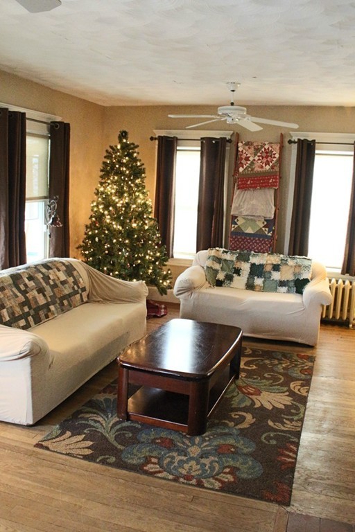 58 Larkspur Street Springfield, MA 01108 - Photo 5 of 29 a living room with large window and potted plant