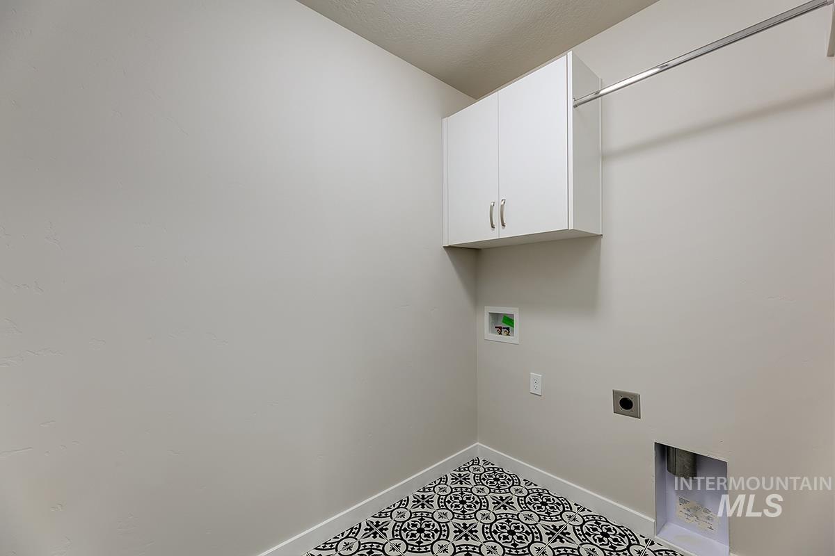 7080 South Gamely Avenue Meridian, ID 83642 - Photo 15 of 30 Laundry room with hookup for an electric dryer, washer hookup, cabinet space, and a textured ceiling
