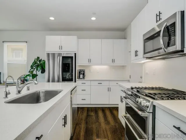 a kitchen with a sink stove and microwave