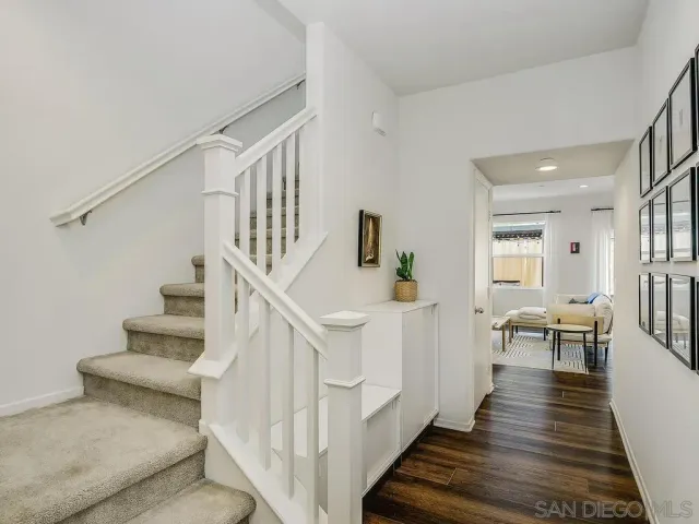 a view of entryway and hall with wooden floor