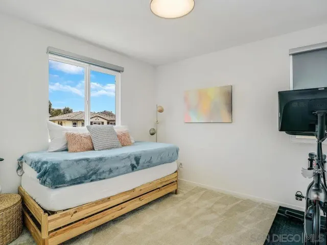 a bedroom with a bed and flat screen tv
