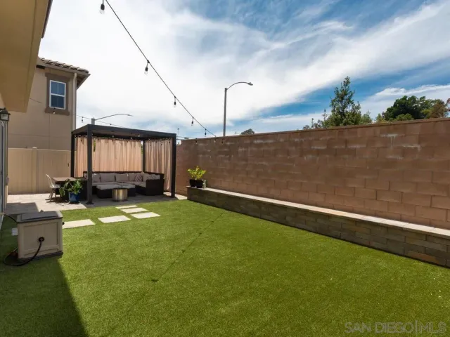 a view of a backyard with sitting area