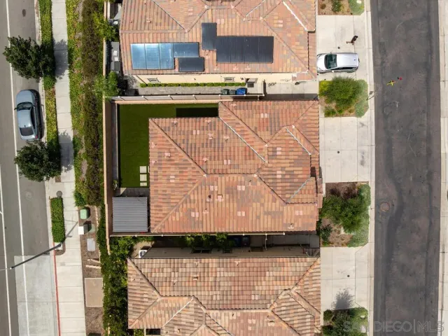a view of a street with potted plants
