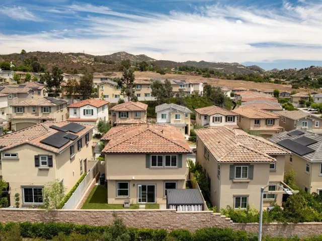 a view of residential houses with a city view