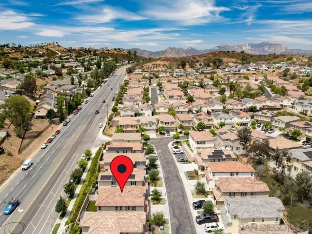 an aerial view of residential houses with outdoor space