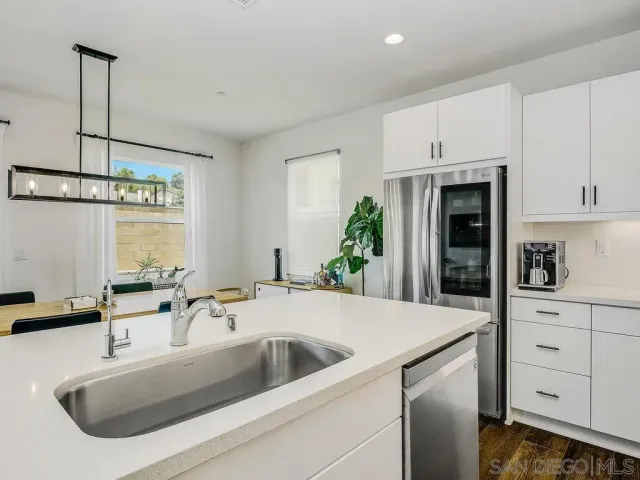 a kitchen with a sink and refrigerator
