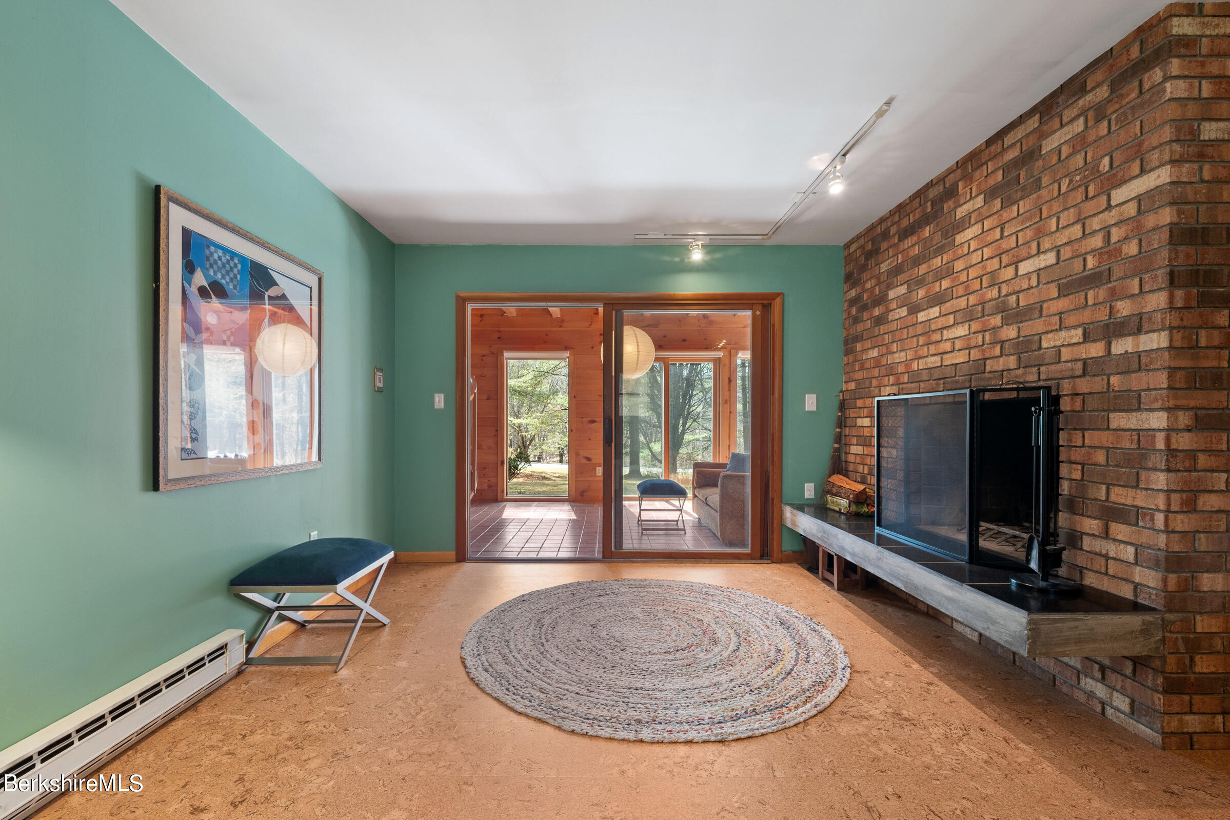 11 Pine Knoll Road Lenox, MA 01240 - Photo 12 of 35 a living room with furniture a flat screen tv and a fireplace