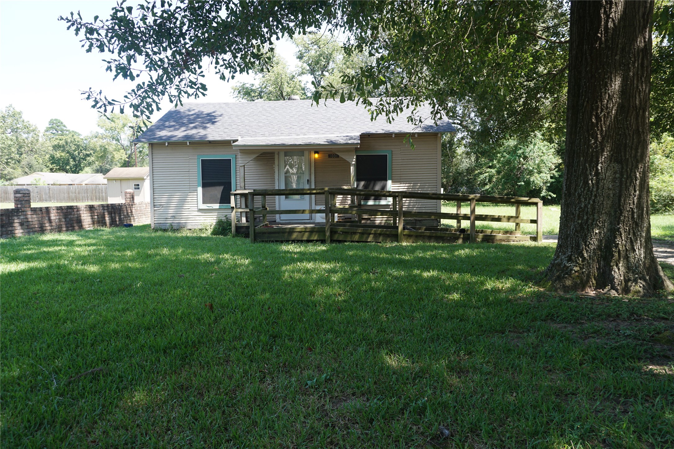 a view of a house with a yard and sitting area