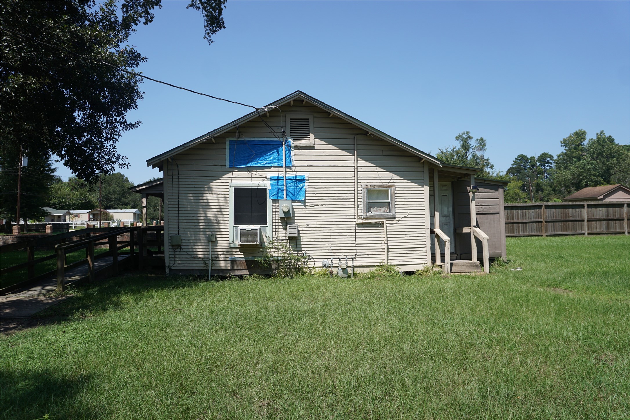 1031 South 5th Street Conroe, TX 77301 - Photo 3 of 5 a front view of a house with a yard