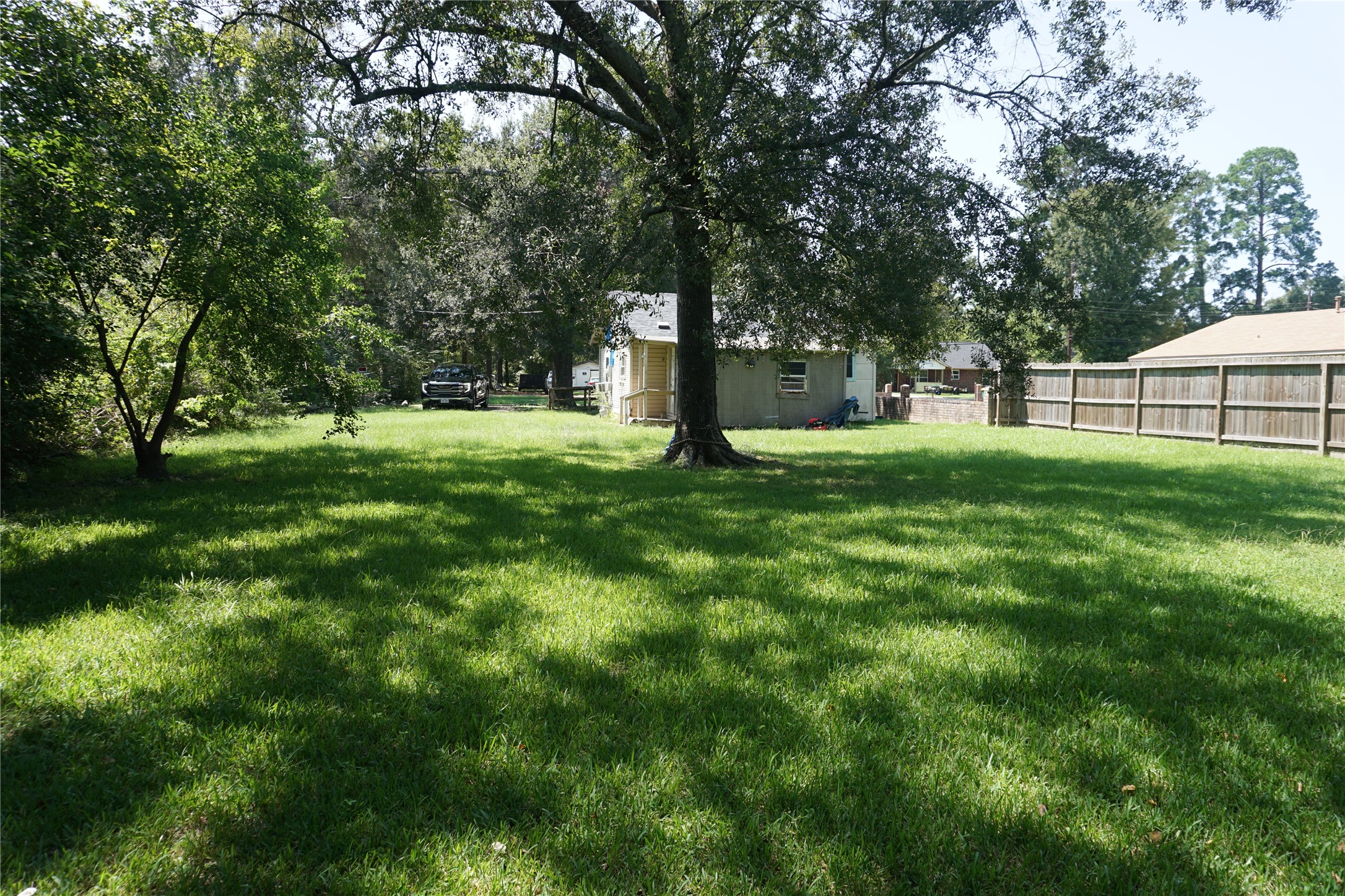 1031 South 5th Street Conroe, TX 77301 - Photo 4 of 5 a view of a backyard with large trees