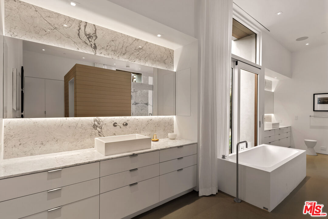 6728 Wildlife Road Malibu, CA 90265 - Photo 20 of 57 a bathroom with a double vanity sink mirror and bathtub