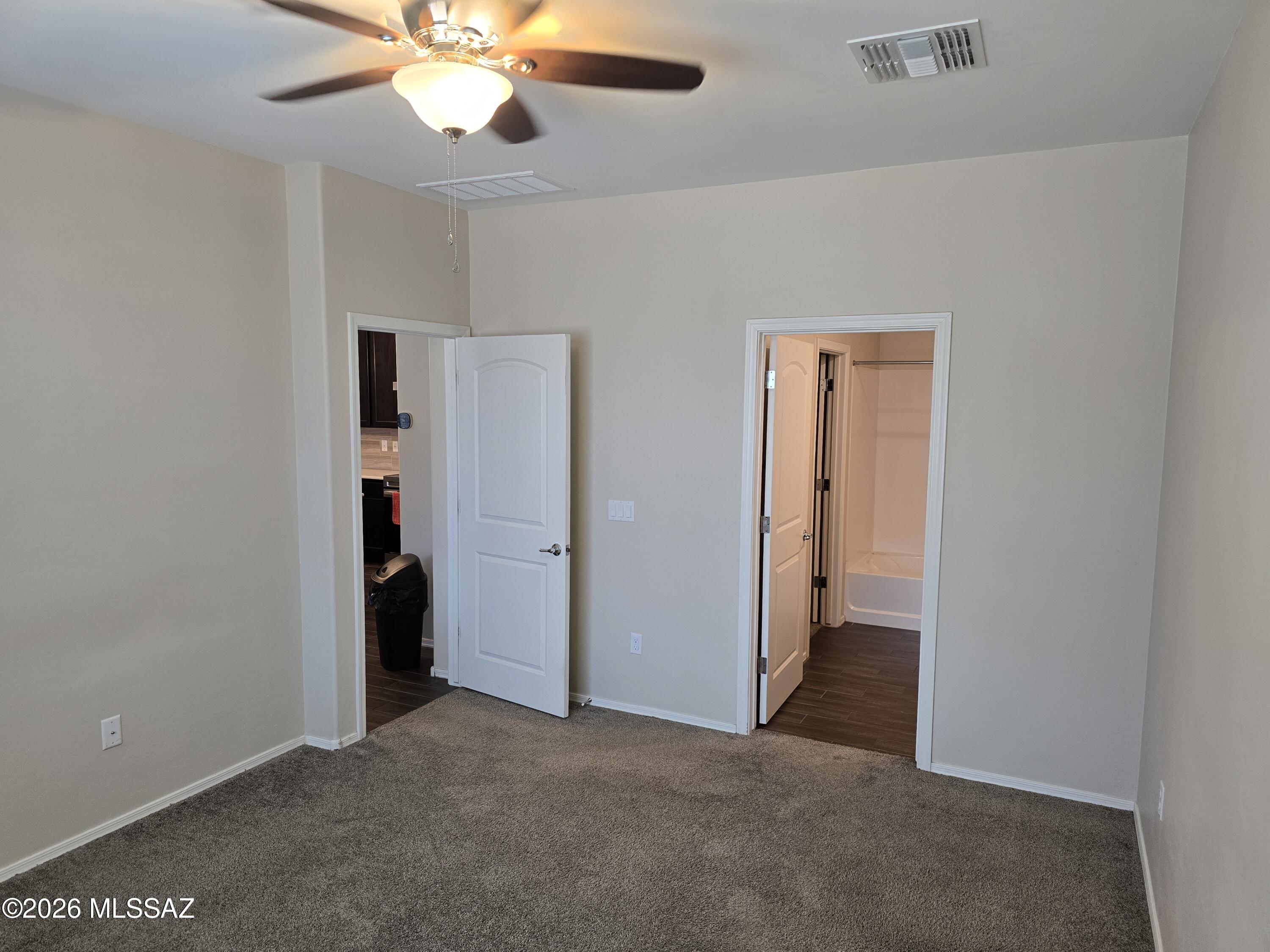 6151 South Antrim Loop Tucson, AZ 85706 - Photo 7 of 13 an empty room with closet and a ceiling fan