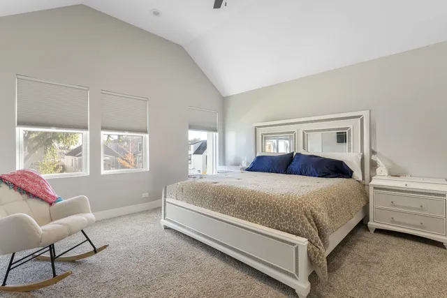 a bedroom with a bed chair and window