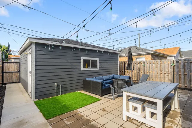 a view of a patio with a table and chairs