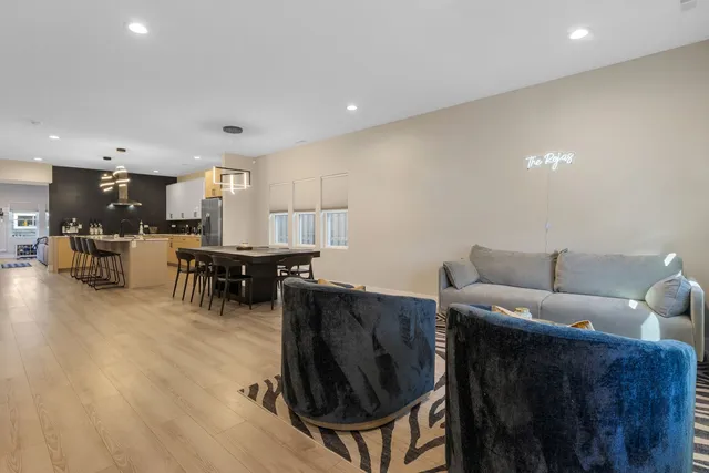 a living room with furniture and kitchen view