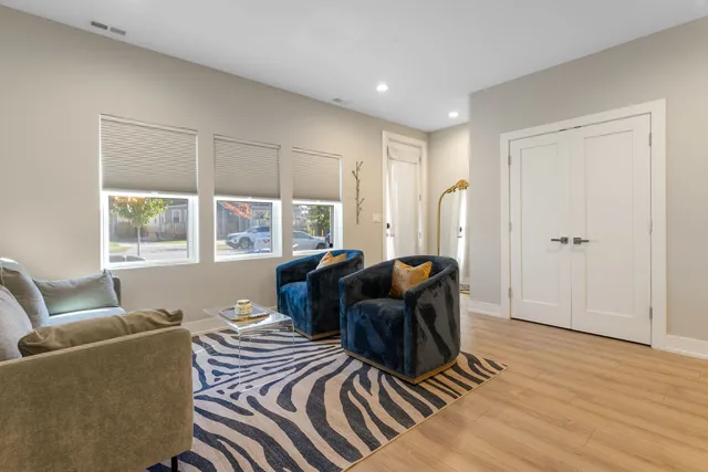 a living room with furniture and two window