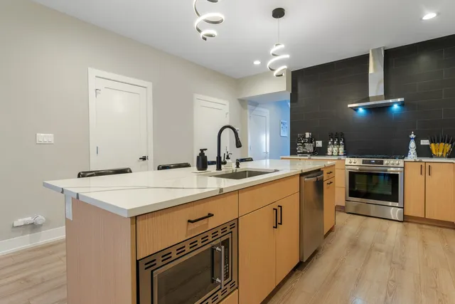 a kitchen with a stove a sink and a refrigerator