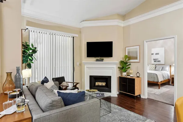 a living room with furniture a potted plant and a fireplace