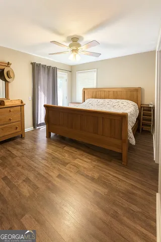 a spacious bedroom with a bed and a dresser