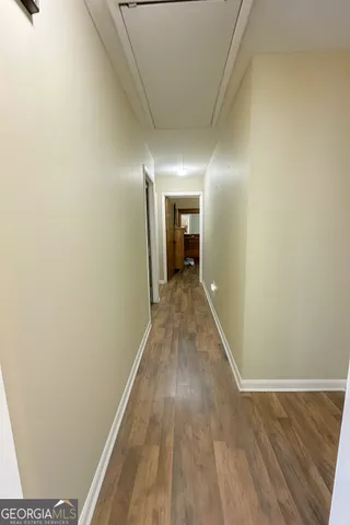 a view of a hallway with wooden floor