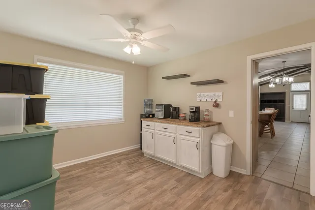 a kitchen with a sink cabinets and wooden floor