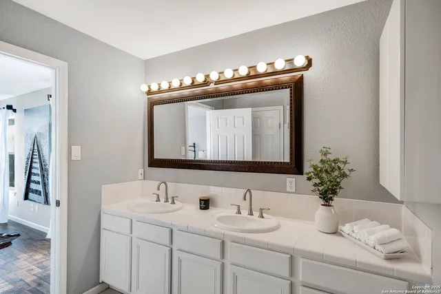 a bathroom with a sink and a mirror