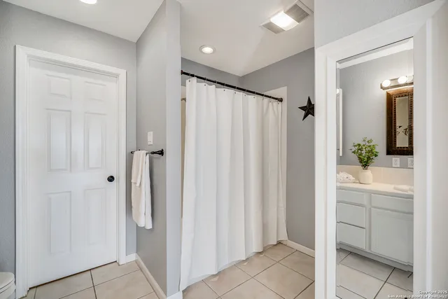 a bathroom with a shower and a sink