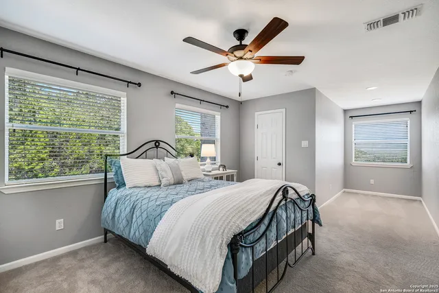a bedroom with a large bed and a large window