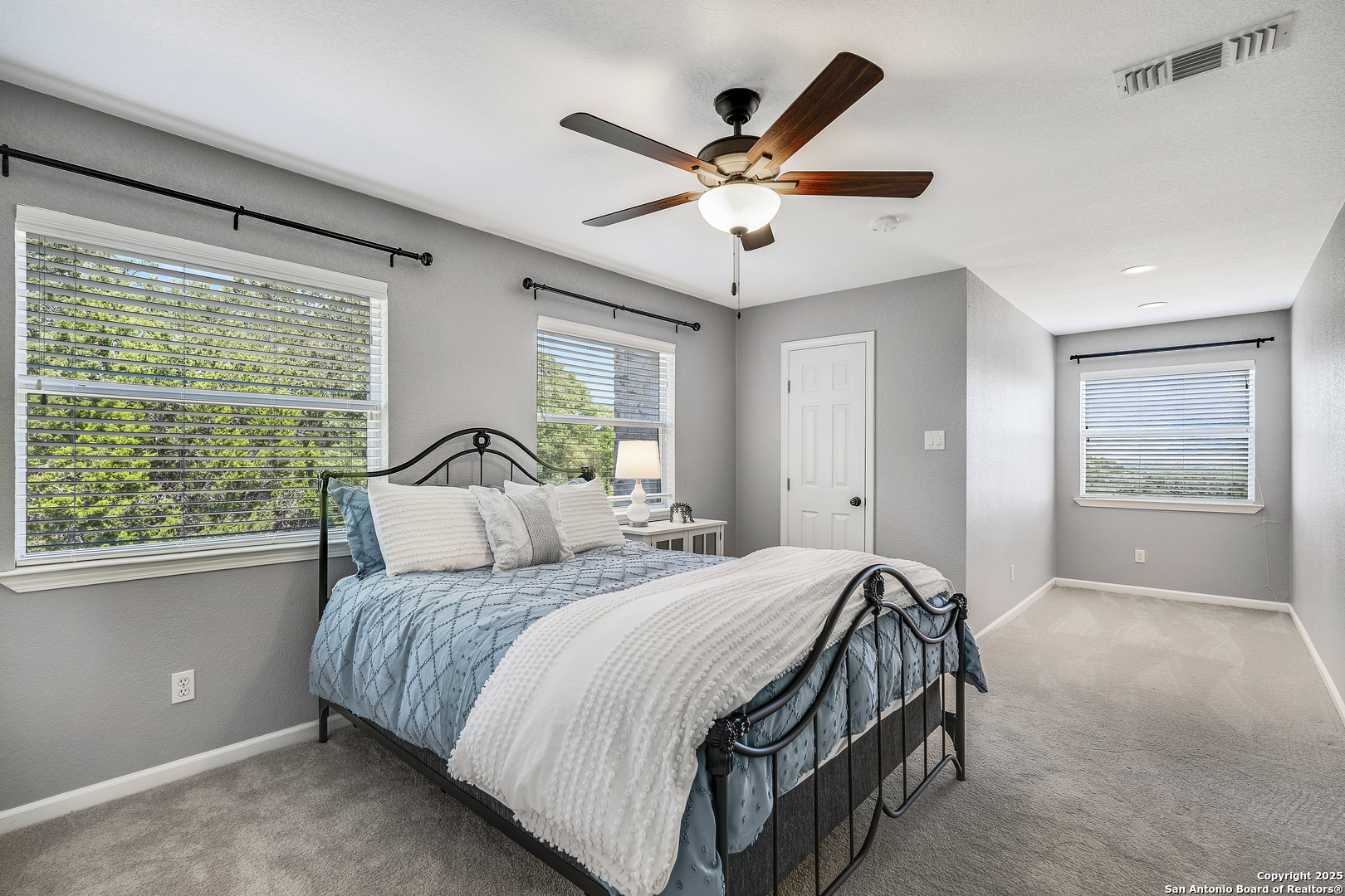 107 Ridge View Drive Boerne, TX 78006 - Photo 18 of 53 a bedroom with a large bed and a large window