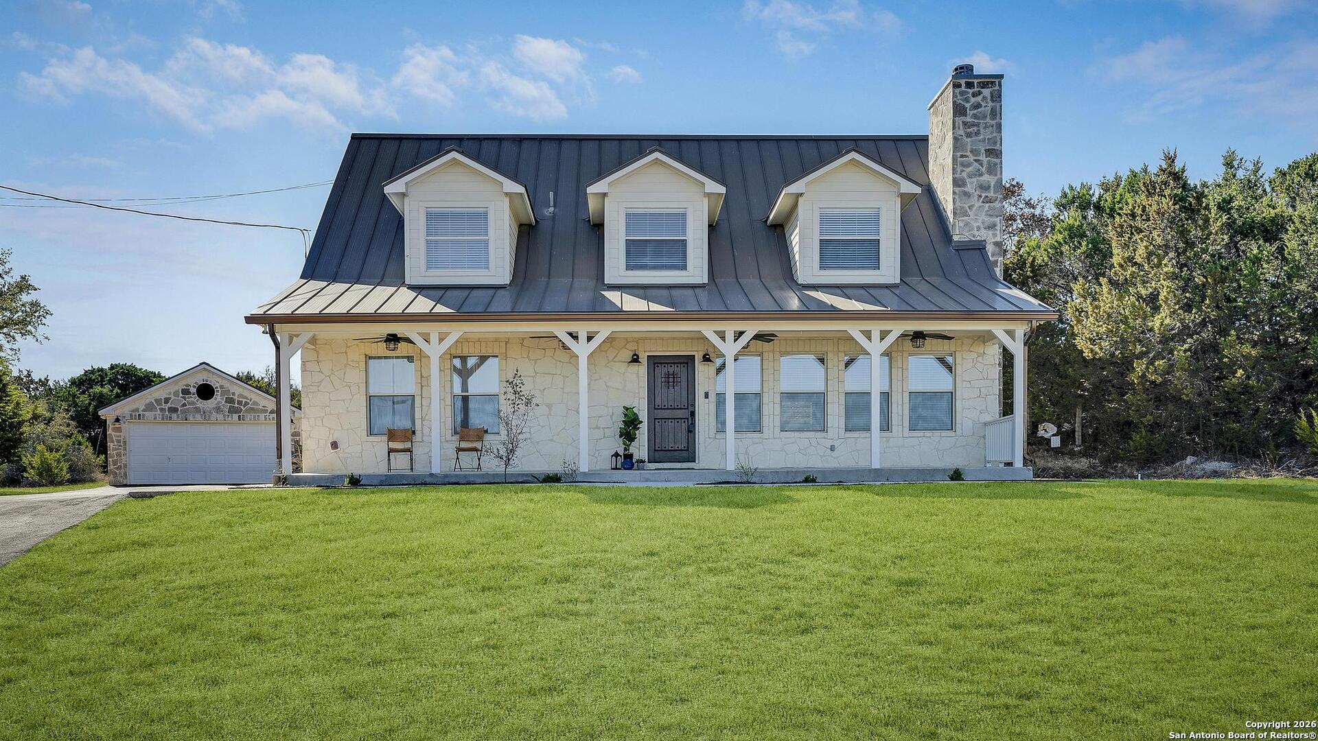 107 Ridge View Drive Boerne, TX 78006 - Photo 2 of 53 a view of a white building with a big yard and large trees